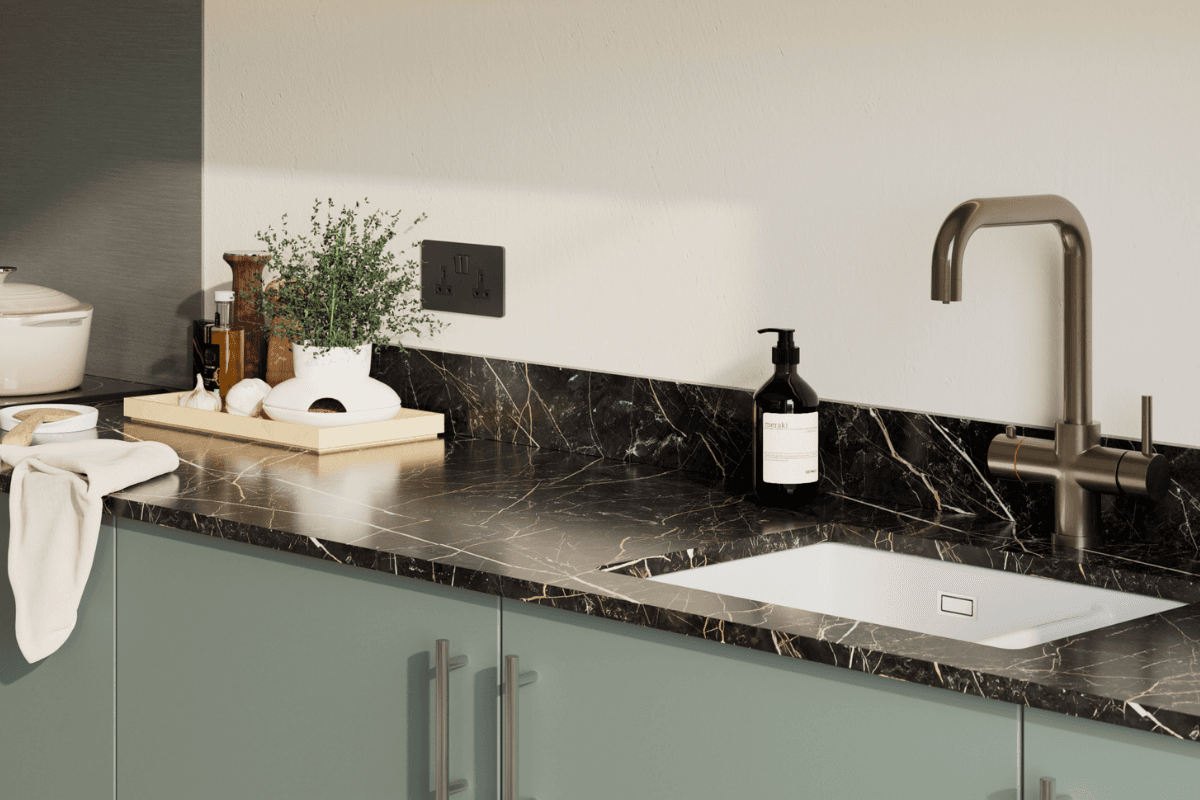 Kitchen with black worktop and white and copper vein detailing