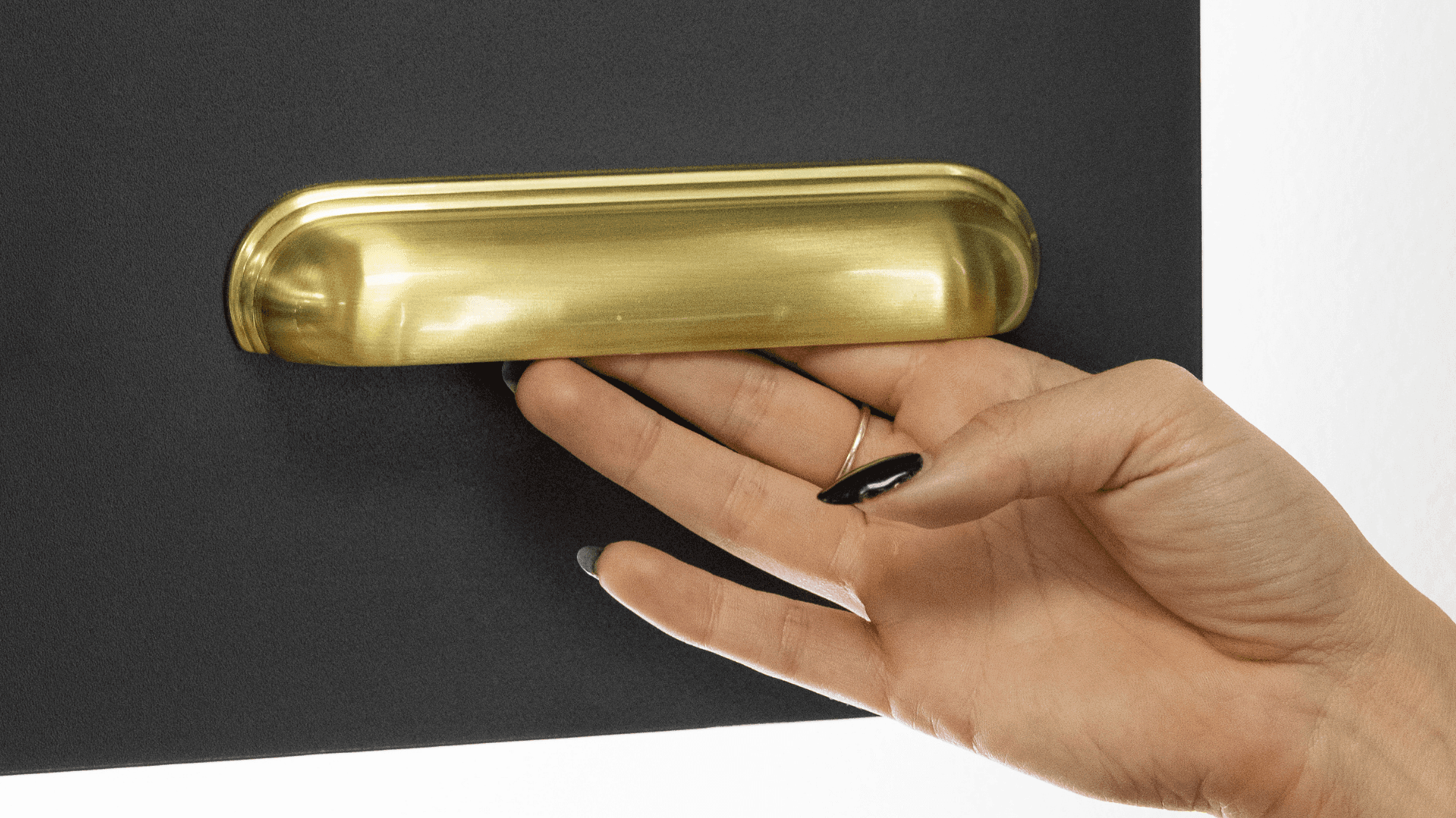 Customer looking at modern brass cup handle