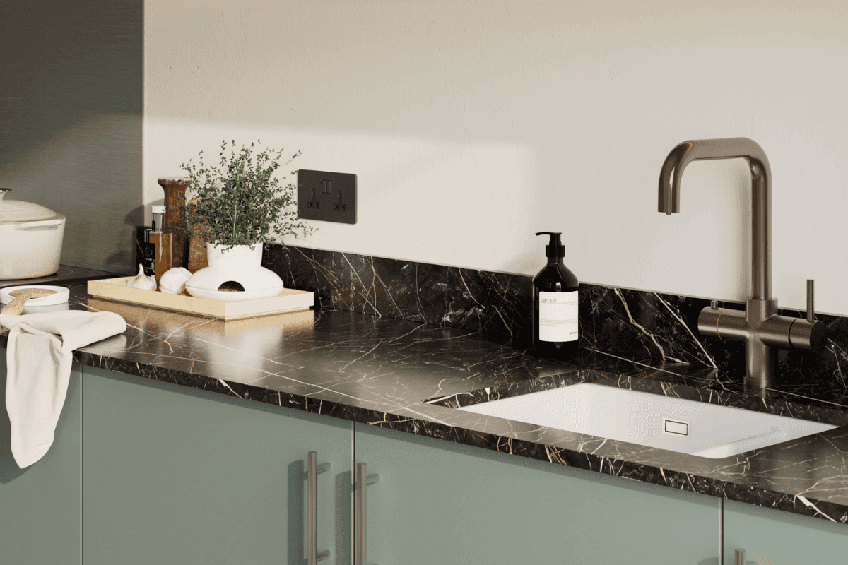 Kitchen with black worktop and white and copper vein detailing