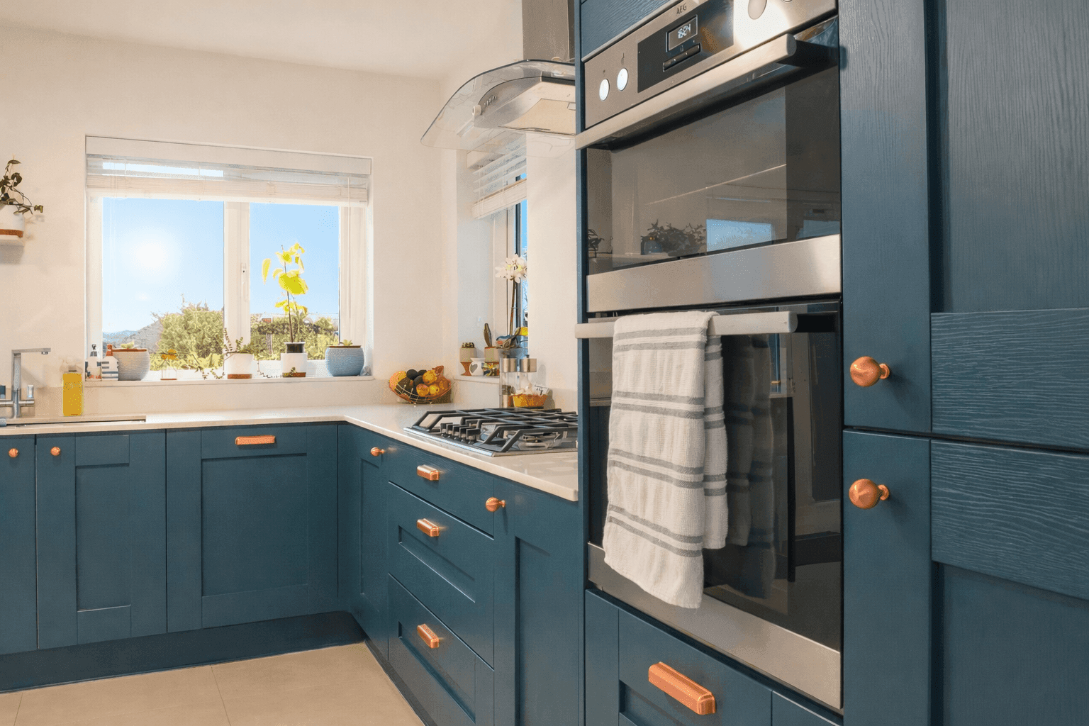 Shaker kitchen with blue doors and copper cup and knob handles