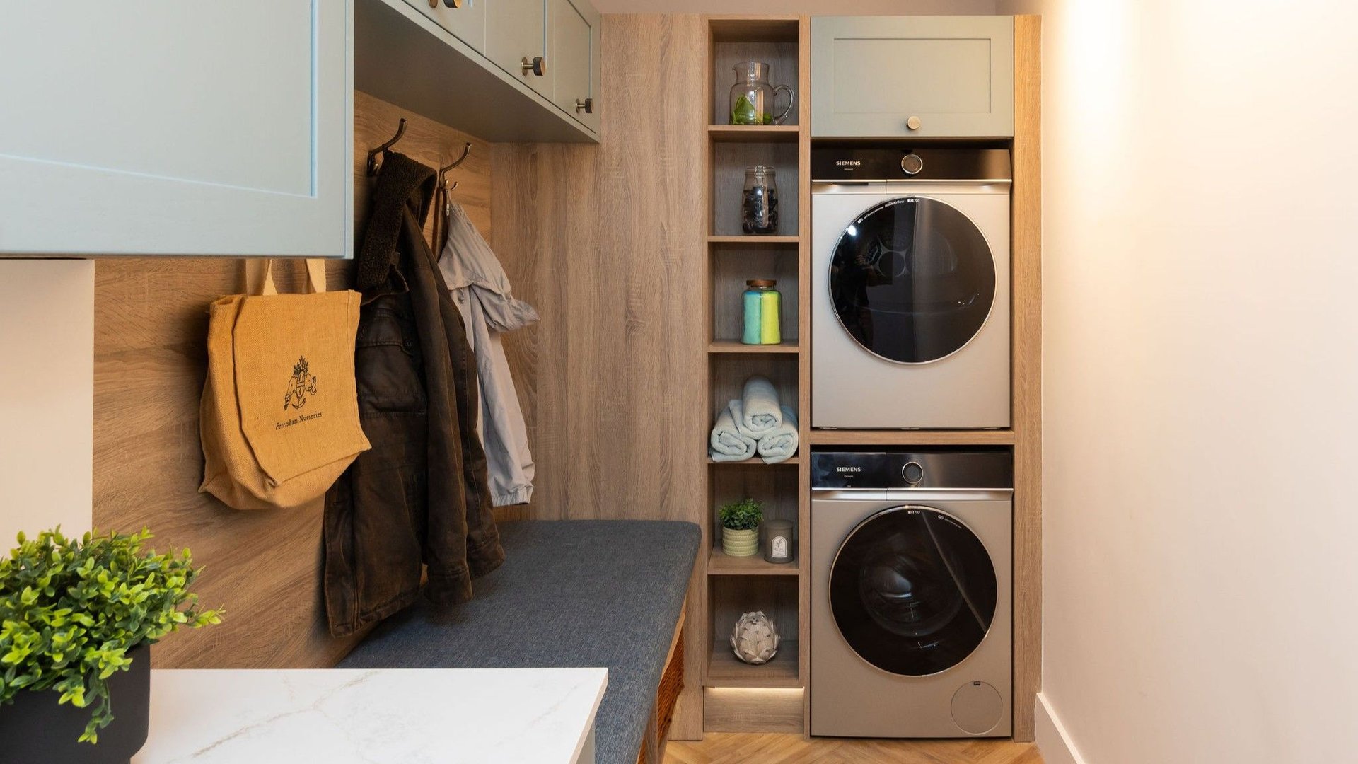 Utility with Fishbourne Light Teal shaker doors and stacked laundry appliances