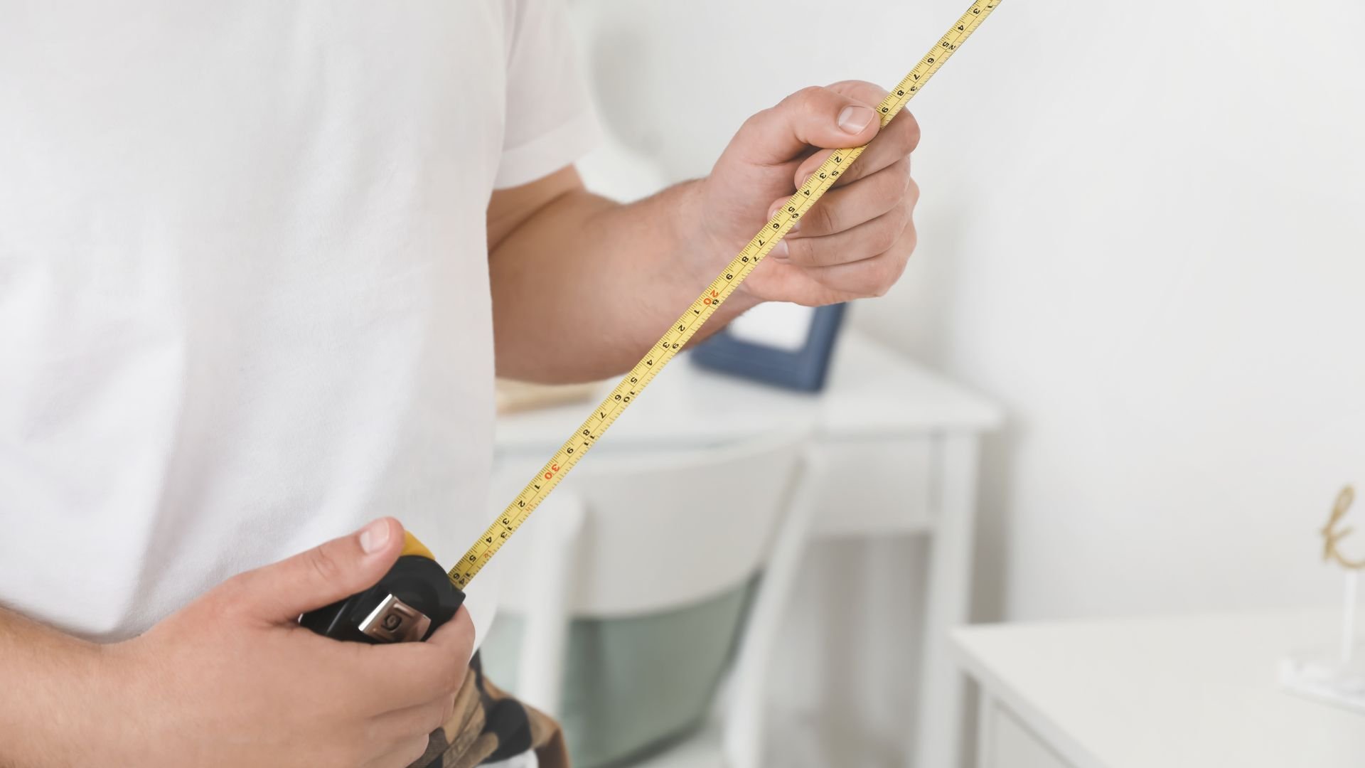 Person holding a tape measure