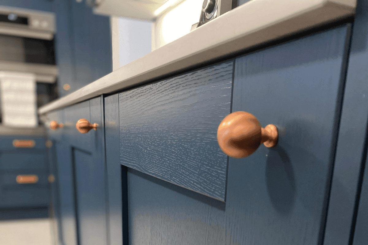 Shaker kitchen with blue doors and copper cup and knob handles