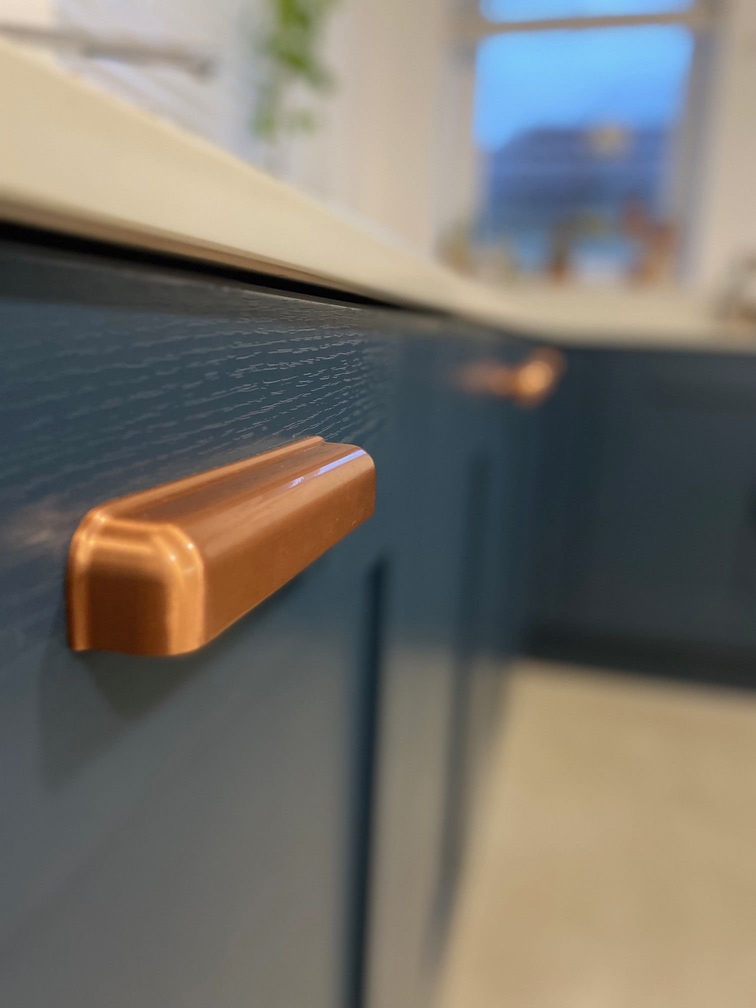 Shaker kitchen with blue doors and copper cup and knob handles