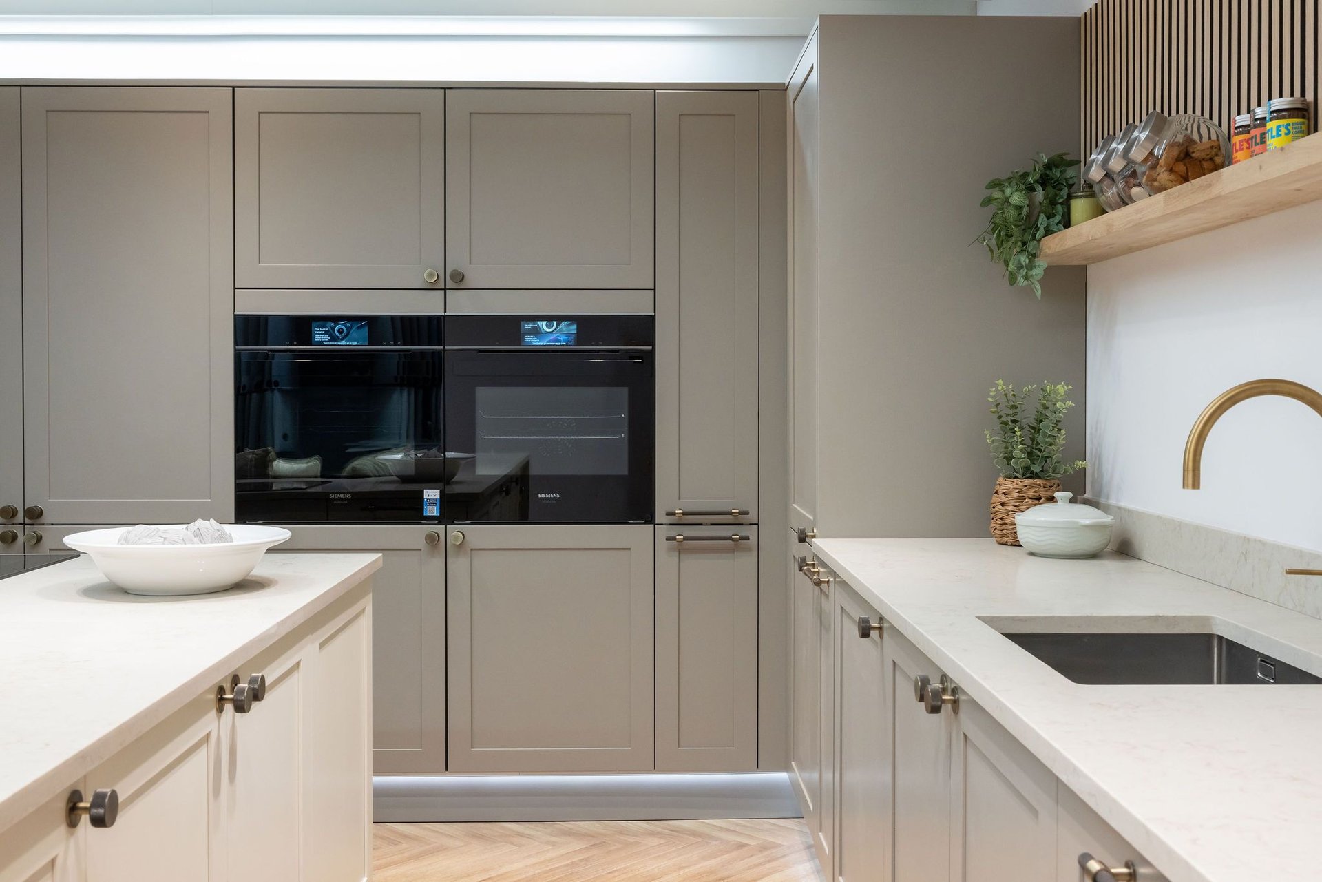 Kitchen with Petworth Stone Grey shaker doors, white worktop and bar and knob handles
